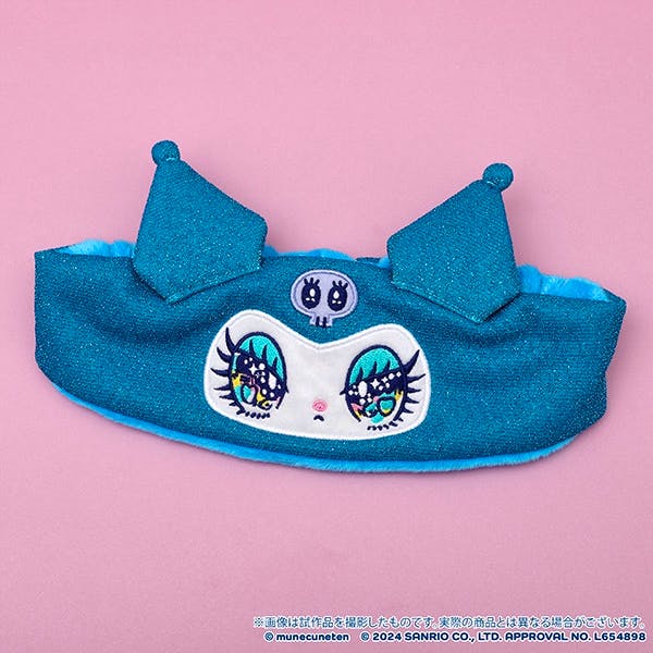 Blue Kuromi-themed hair band with an embroidered face, skull motif, and two pointy ears displayed on a pink background.