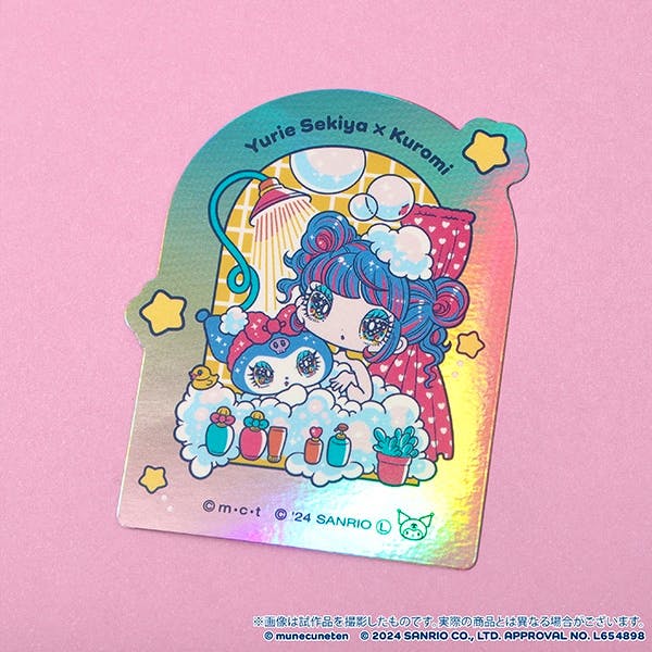 Holographic sticker showing the Yurie Sekiya × Kuromi design of a girl and Kuromi in a bubbly bathtub on a pink background.