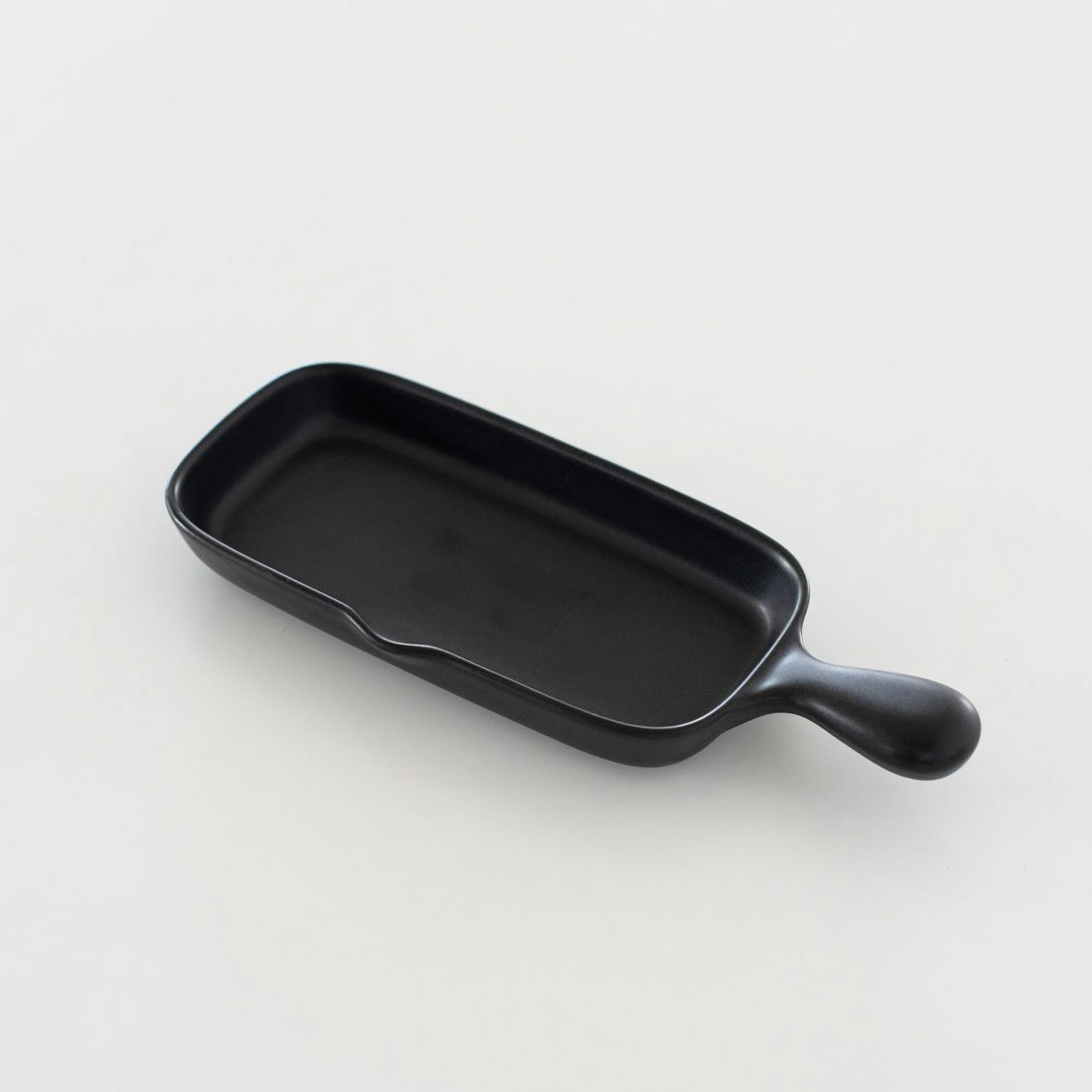 A black rectangular half-size grill plate with a handle shown on a white background.