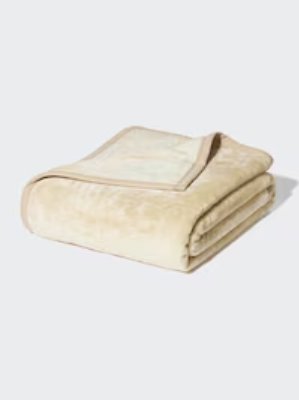 Folded cream-colored polyester double blanket displayed on a white background.