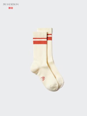 Cream-colored acrylic ribbed socks with red stripes shown together on a light background.