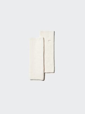 A cream-colored fleece neck warmer laid flat on a light background.