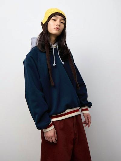 Model wearing the Heavy Weight Sweat Cocoon Hoodie (bicolor), front three-quarter view showing the hood and hem.