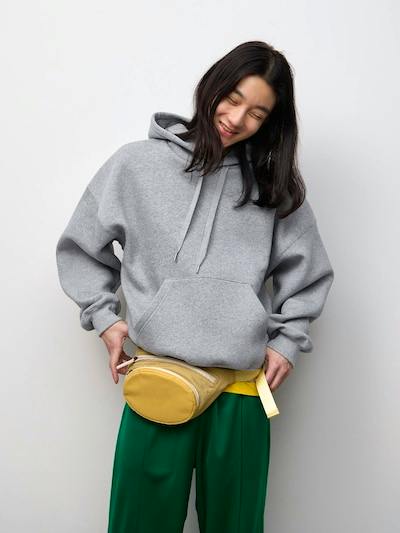 A model wearing a gray heavyweight cocoon-style oversized hoodie against a plain light background.
