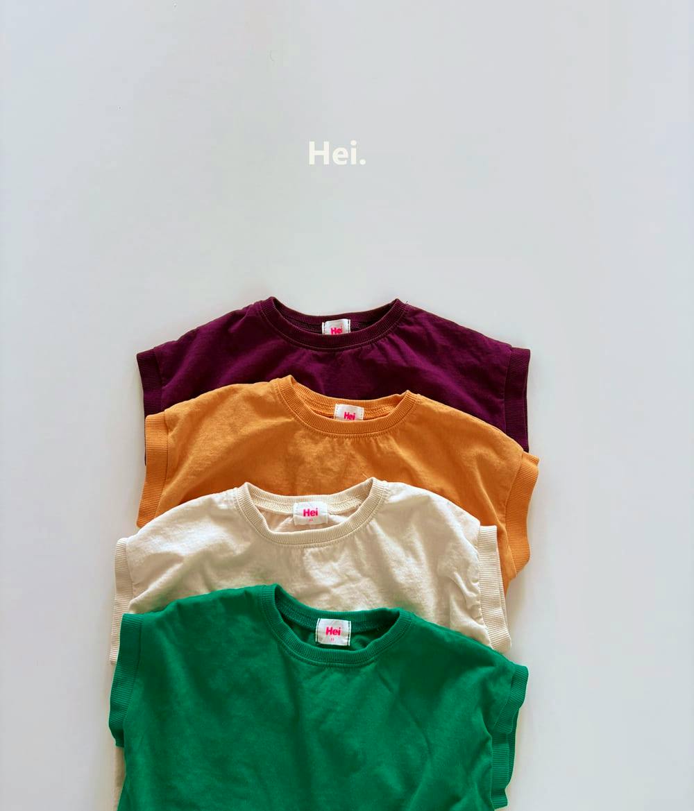Four children's cotton shirts — purple, orange, cream, and green — are stacked vertically on a white background with the “Hei.” label visible.