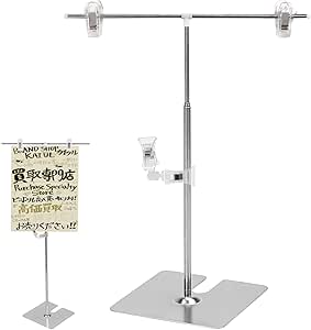 Silver height-adjustable T-shaped poster stand with two clear clips on a horizontal bar and a flat stainless steel base.