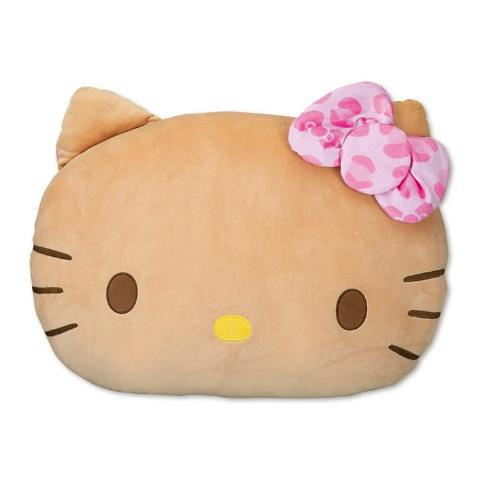 A big Hello Kitty cushion showing the character's beige face with brown eyes, a yellow nose, whisker lines, and a pink patterned bow.