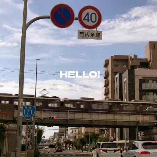 Cover art for the CD showing a city street with an elevated train and the text "HELLO!" centered in the sky.