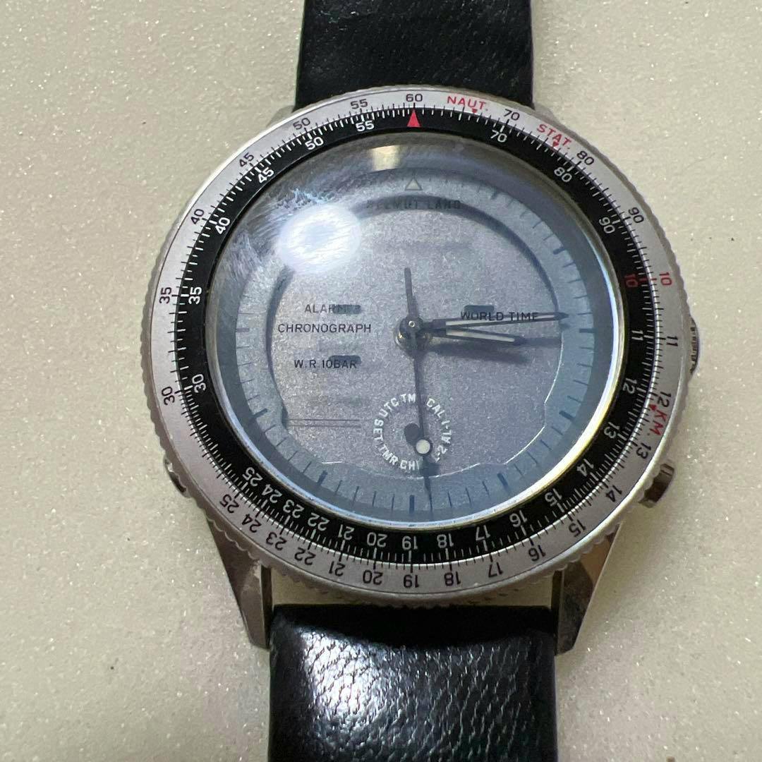 Front view of the Helmut Lang × Citizen Digi-Ana World Time wristwatch showing the round dial, rotating bezel, and black leather strap.