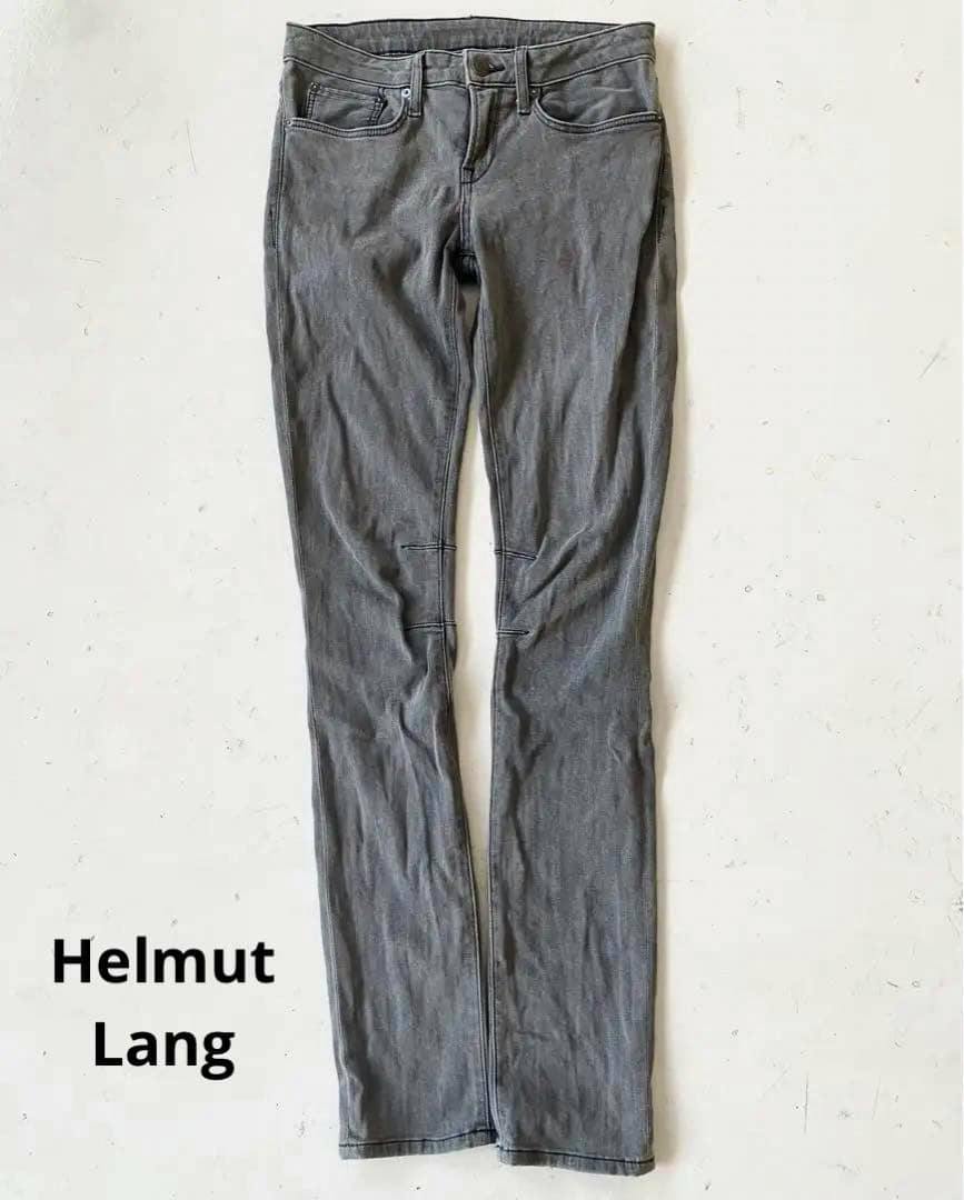 Front view of Helmut Lang gray skinny jeans laid flat on a light background.