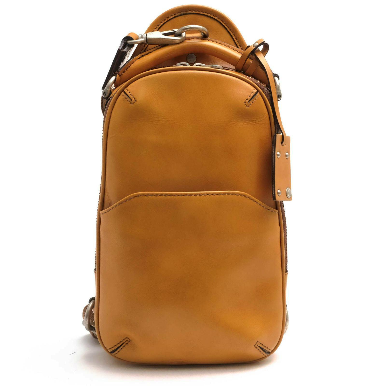 Close-up front view of the brown HERGOPOCH leather shoulder/body bag showing the front pocket, zipper, and leather tag.