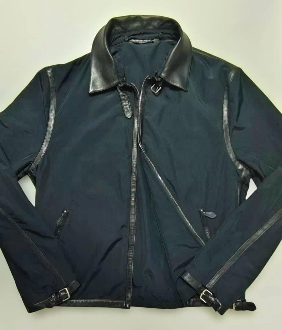Flat-lay photo of the men's nylon jacket with lamb leather collar and leather trim, showing the front zipper and sleeves.