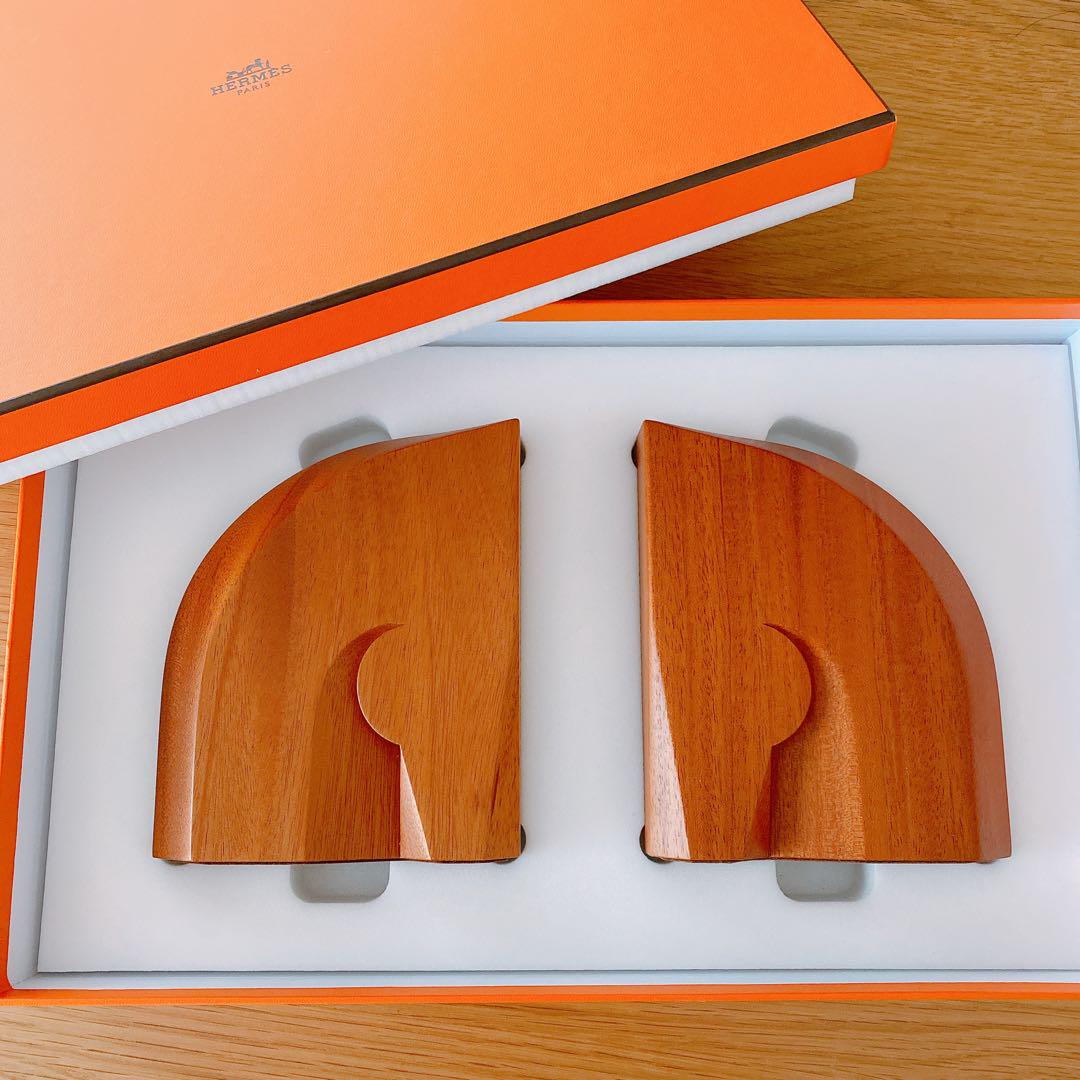 Pair of wooden bookends displayed side by side in an open orange box on a foam insert.