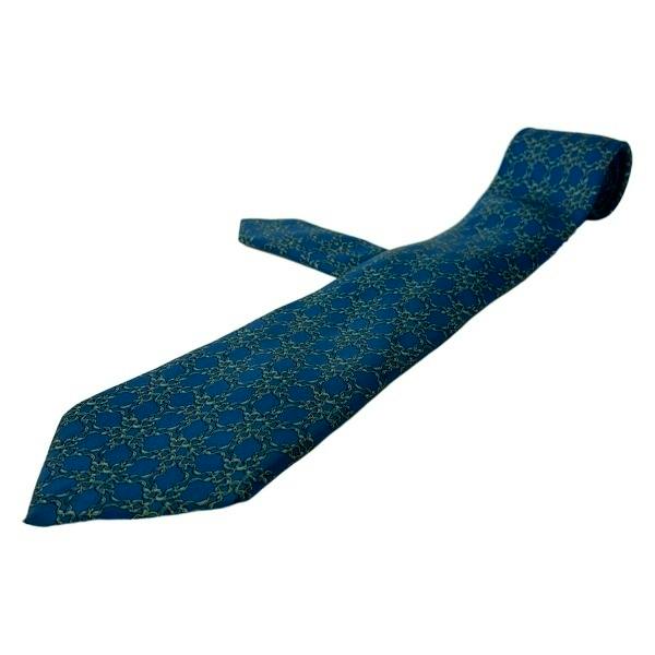 A blue and yellow patterned silk necktie displayed on a white background.