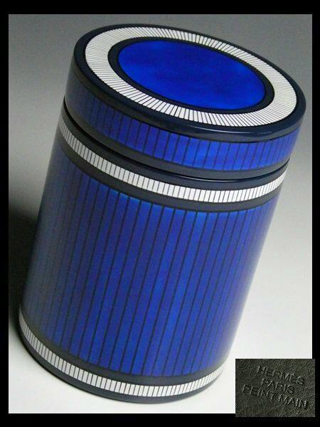 Blue lacquered wooden tea canister with vertical stripe decoration and a matching lid, photographed at an angle.