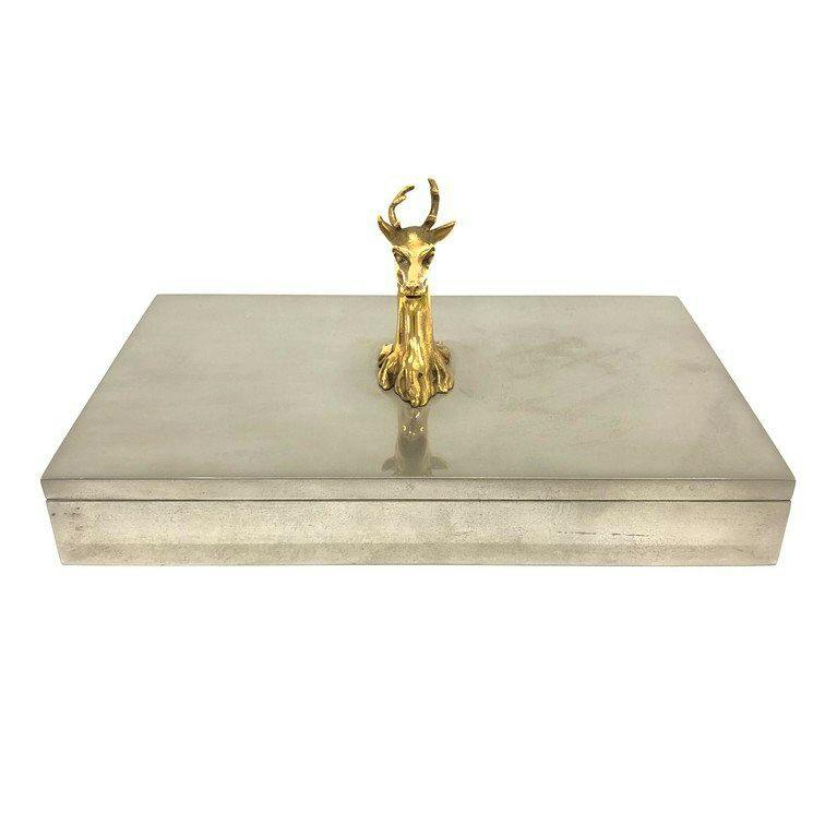 Rectangular metal cigarette case with a gold-colored deer head ornament mounted on the lid.