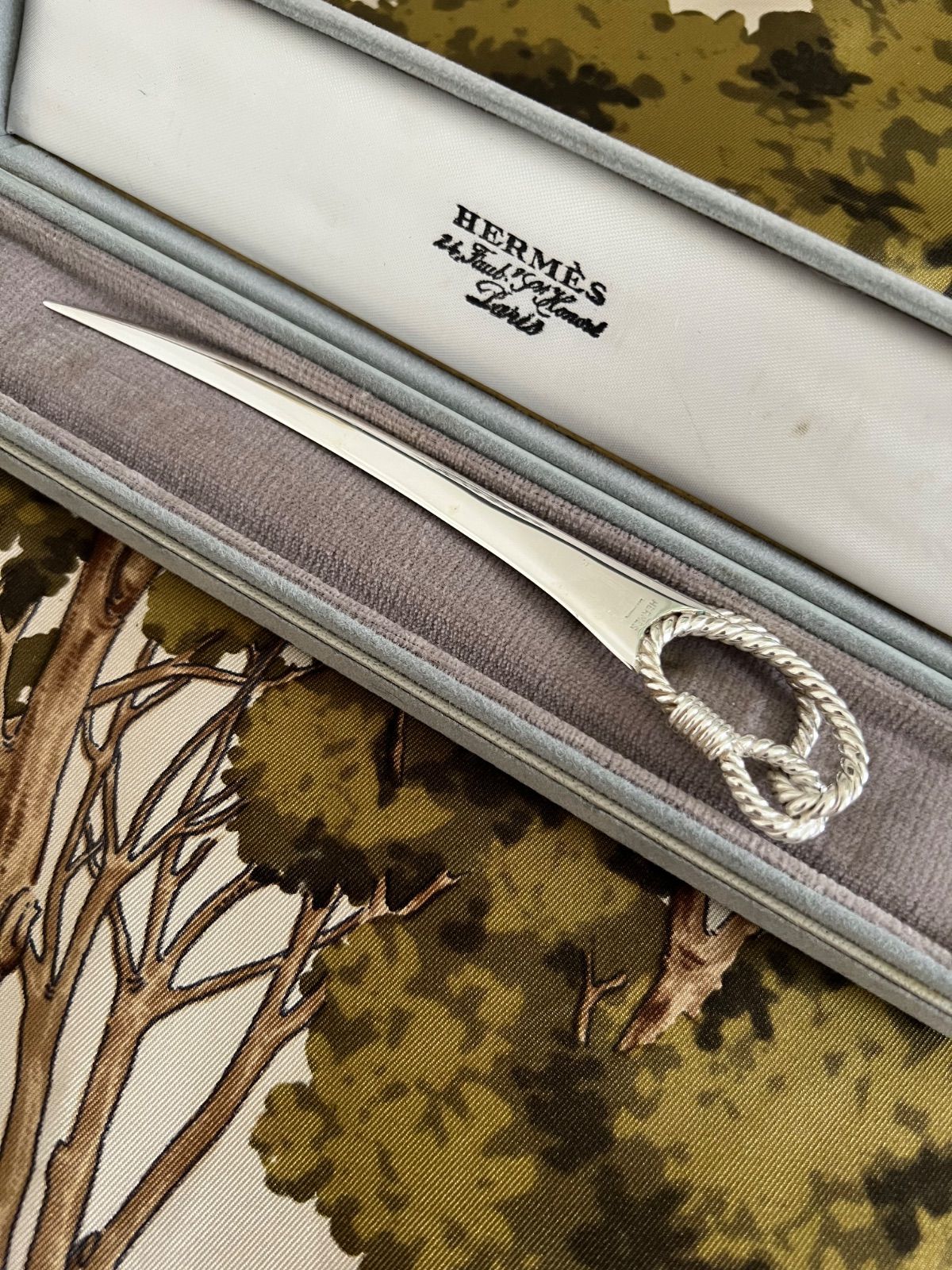 Hermès letter opener with a rope-style handle displayed in its presentation case.