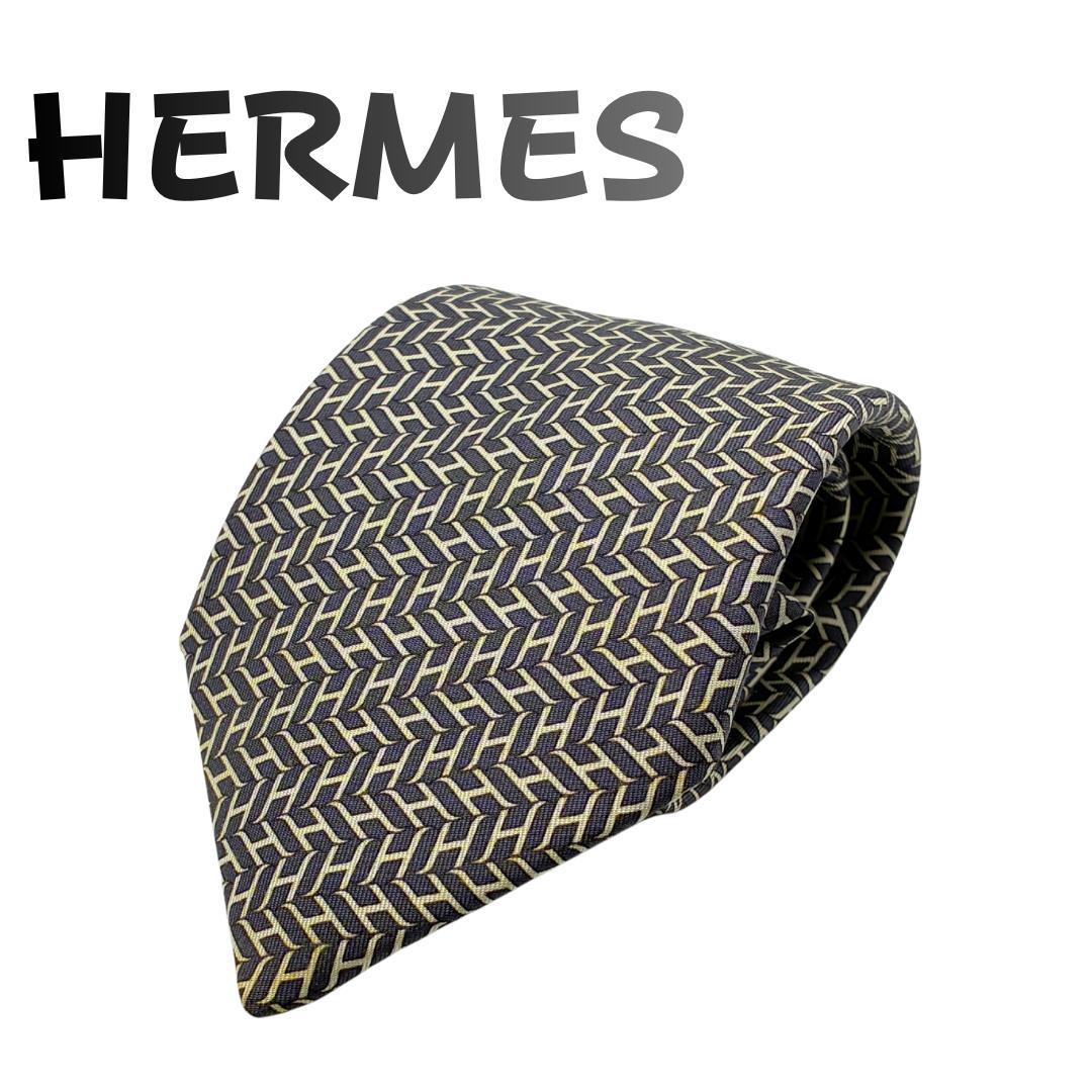 Folded HERMES necktie showing an all-over H patterned design.