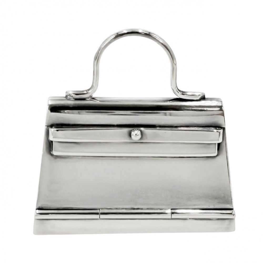 Front view of a silver (925) Hermes Kelly-motif pill case shaped like a small handbag.