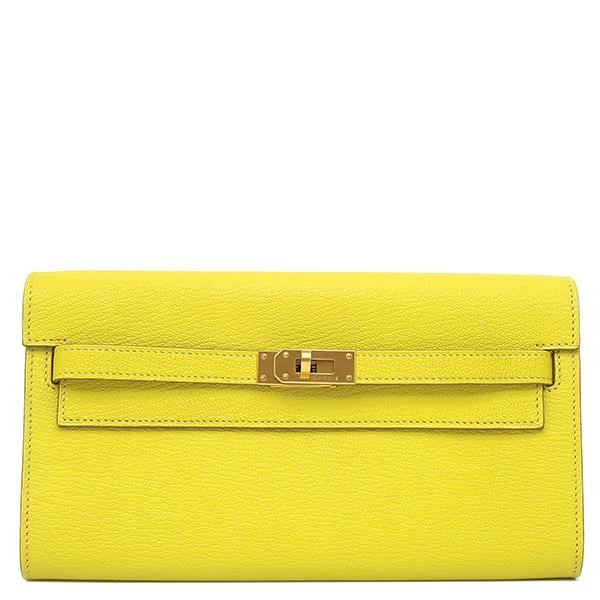 Front view of a lime Hermès Kelly long wallet showing the gold turn-lock hardware.