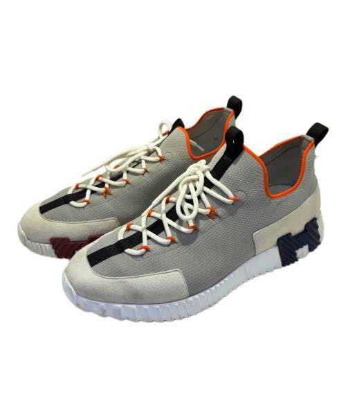 Pair of HERMES Lift slip-on textile sneakers shown at an angle, displaying laces and a textured sole.