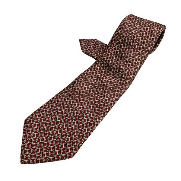 Red, ivory, and gray Hermes men's Chaîne d'Ancre tie laid flat on a white background.