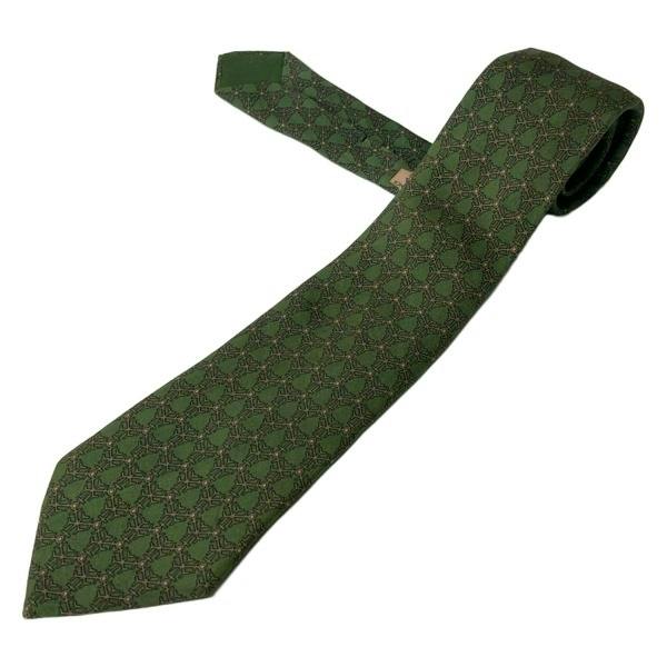 Green patterned Hermès silk men's necktie laid flat on a white background.