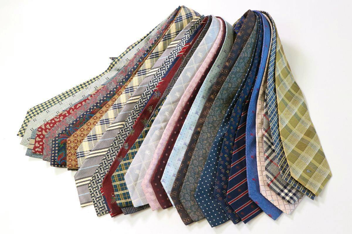 Twenty patterned men’s neckties fanned out and displayed on a white background.