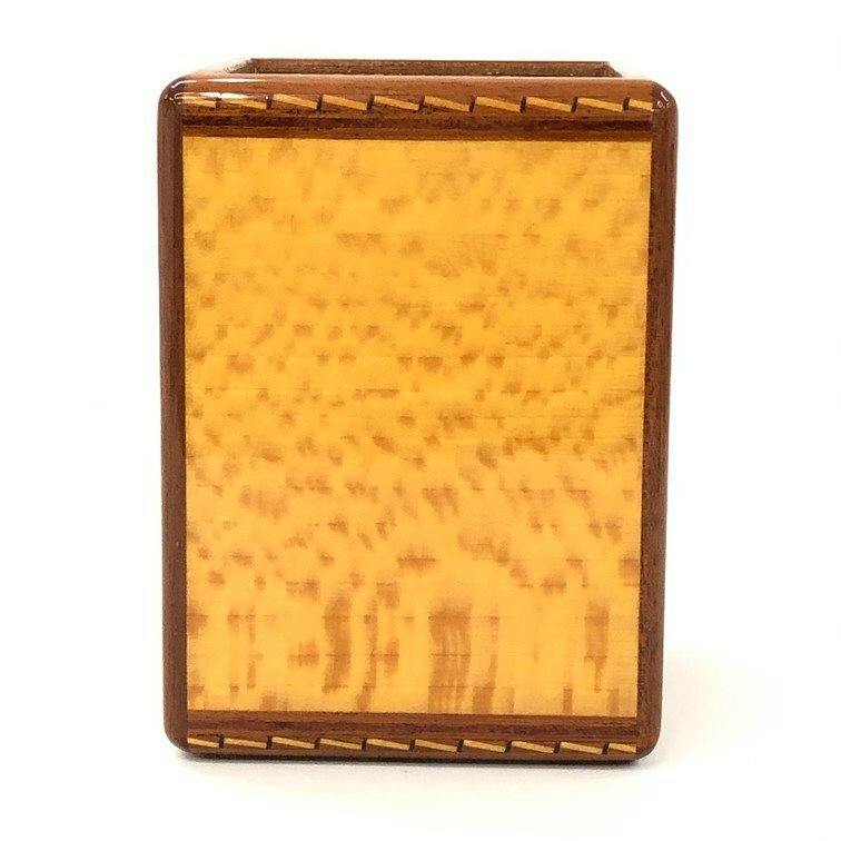 Front view of a HERMES square wooden pen stand showing a light patterned panel and a darker wooden frame.