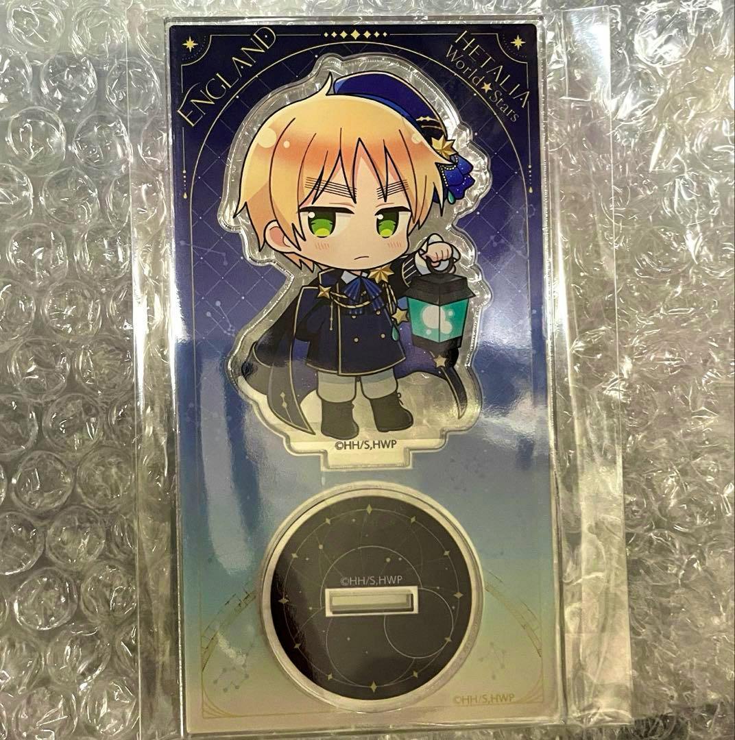 Packaged acrylic stand showing a chibi England character in a starry-themed outfit holding a lantern with its round display base, placed on bubble wrap.