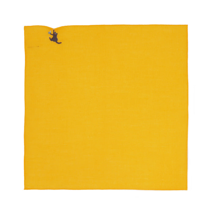 Yellow handkerchief laid flat with a small embroidered black cat hanging from the top-left corner.