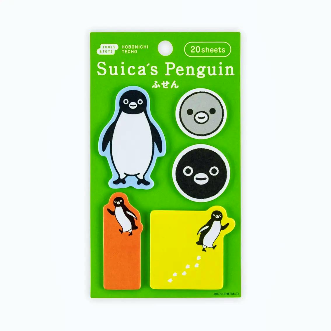 Packaged Suica's Penguin sticky memo pads on a green backing showing six penguin-themed note shapes and a '20 sheets' label.