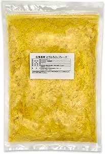 Clear sealed plastic pouch containing yellow corn vegetable flakes with a white product label.