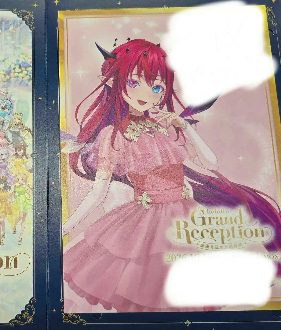 Photograph of an art print showing Hololive character IRyS in a pink dress with the "Grand Reception" logo and a gold decorative border.