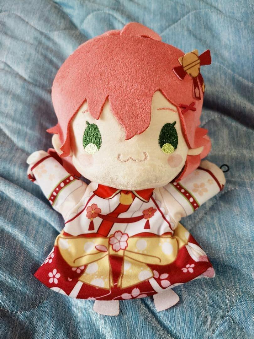 Front view of the Sakura Miko puppet plush with pink hair, embroidered eyes, and a patterned kimono-style outfit.