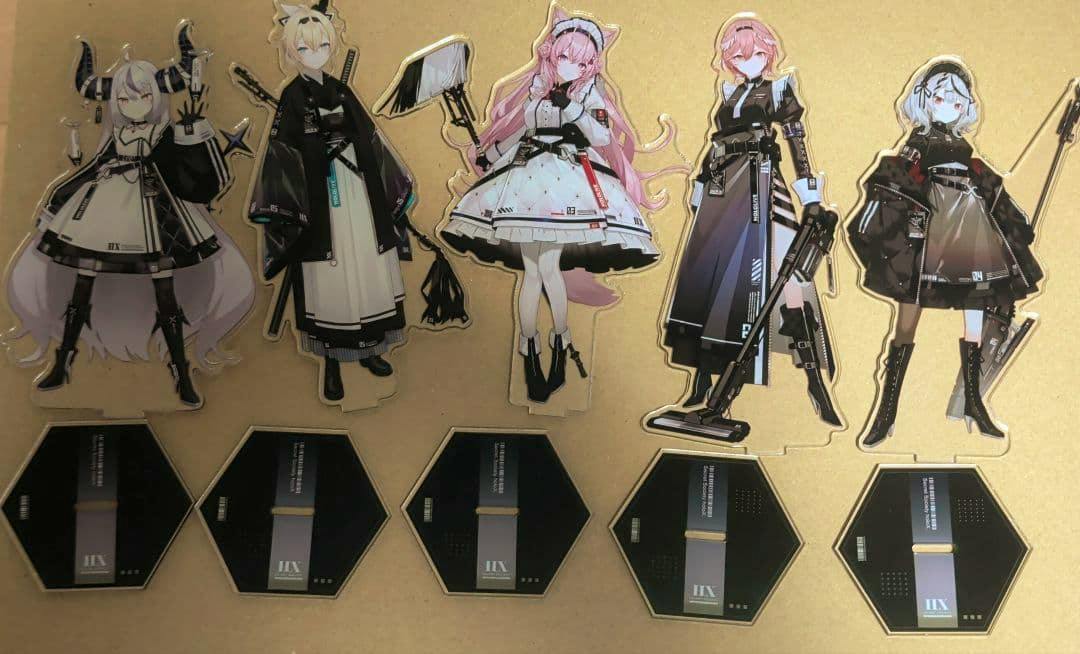 Five holoX “Tactical Maid” acrylic character stands with their five hexagonal bases arranged on cardboard backing.