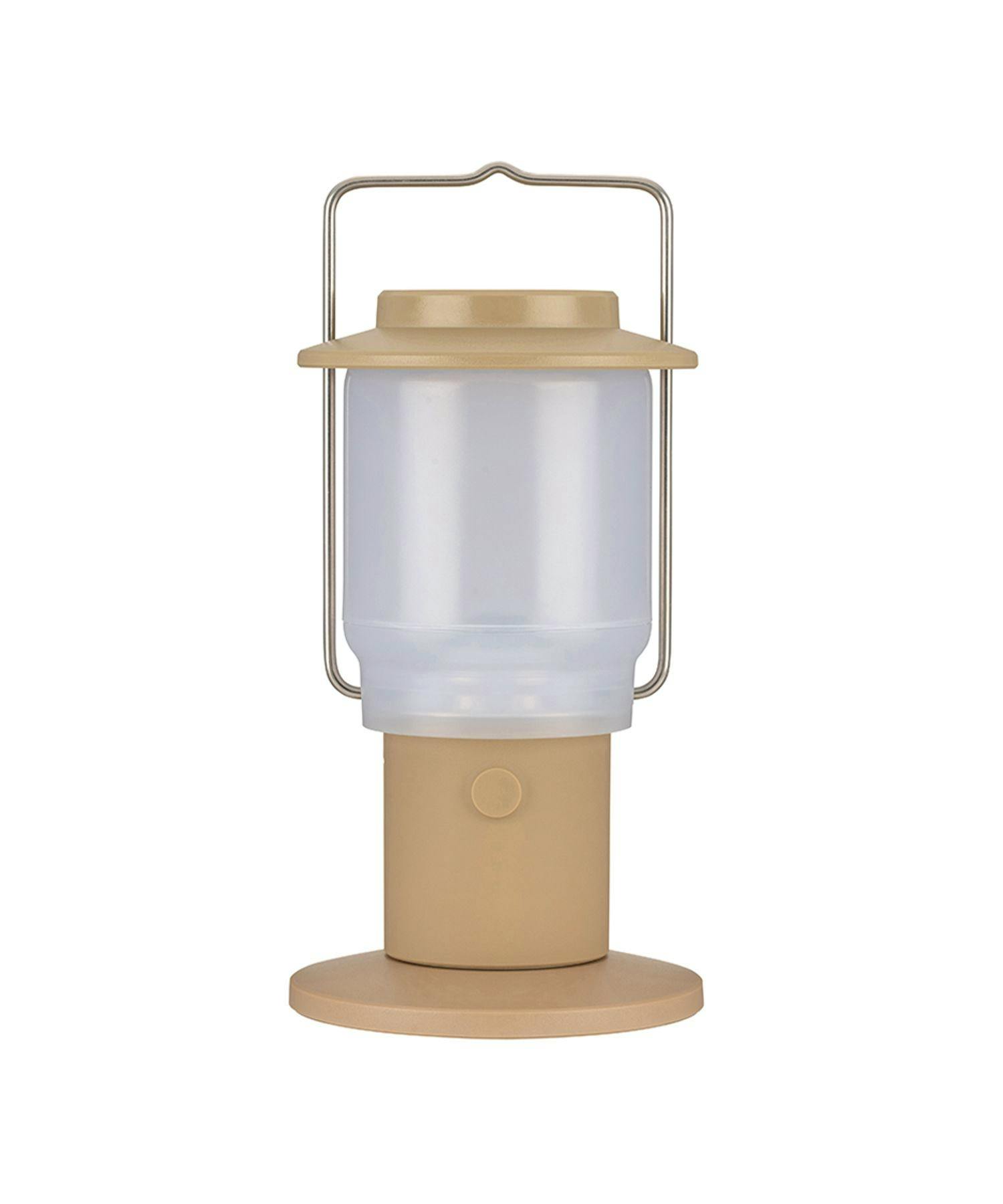 Close-up of the khaki HOME&CAMP handheld lantern showing the top, metal handle, diffuser, and base.
