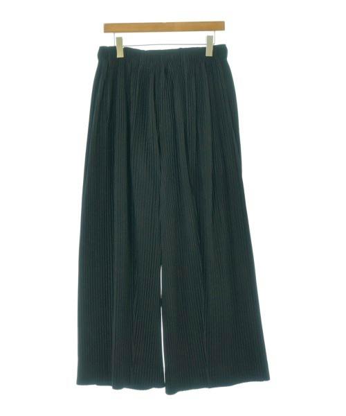 Pleated wide-leg men's polyester pants hanging on a hanger against a white background.