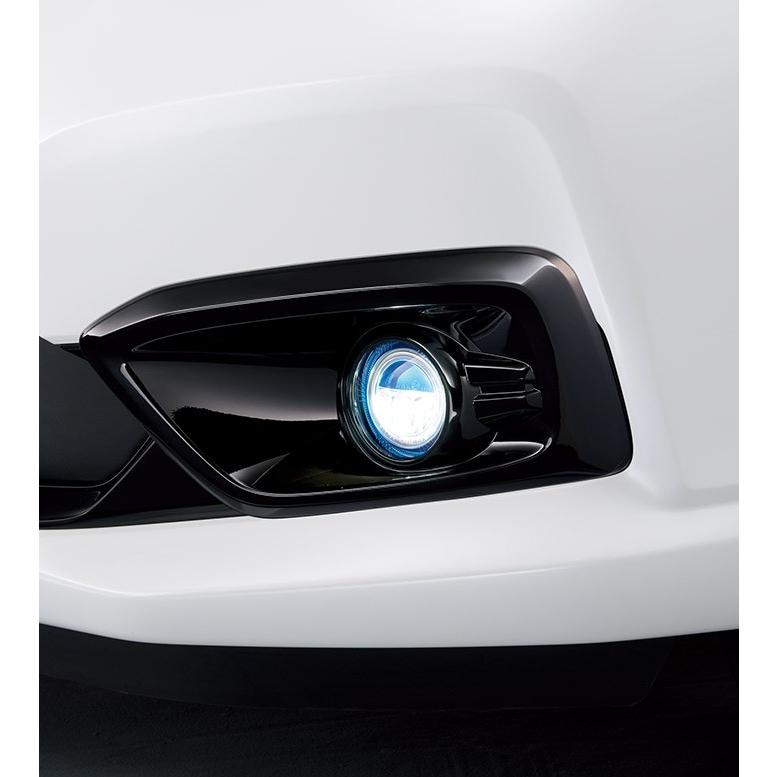 Close-up of a Honda front bumper showing a clear LED fog light installed in the fog lamp housing.