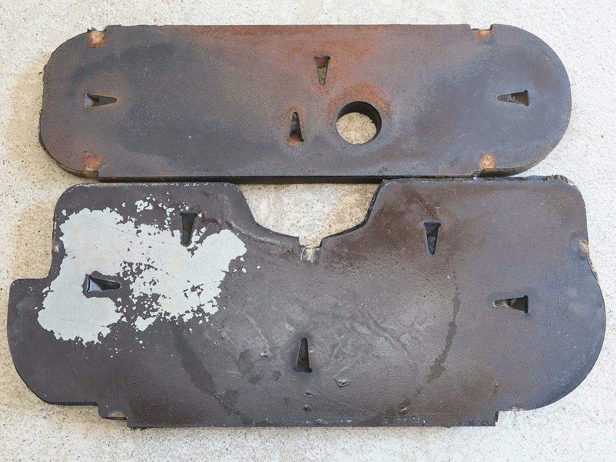 Two metal exhaust heat shield panels for a Honda TN360 showing rusted exterior surfaces.
