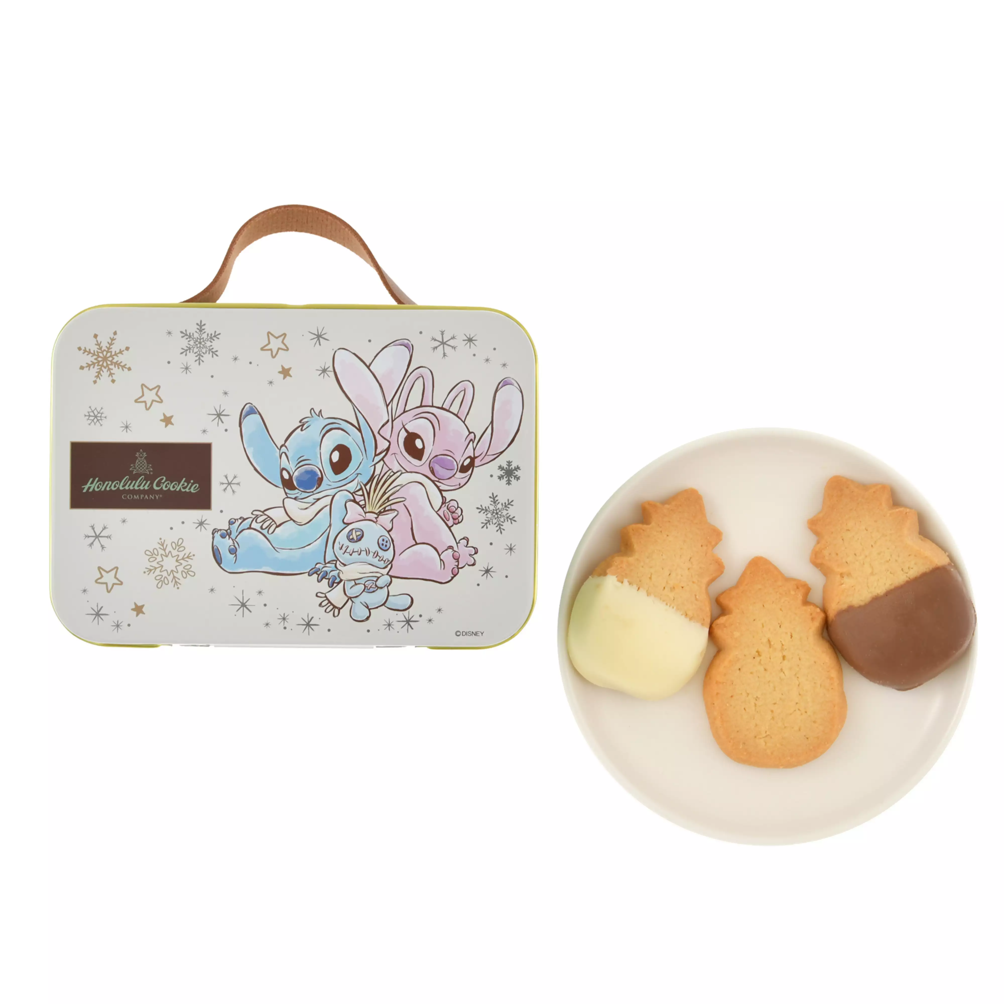 A trunk-style tin featuring Stitch, Angel, and Scrump with snowflake decorations beside a plate of three cookies.