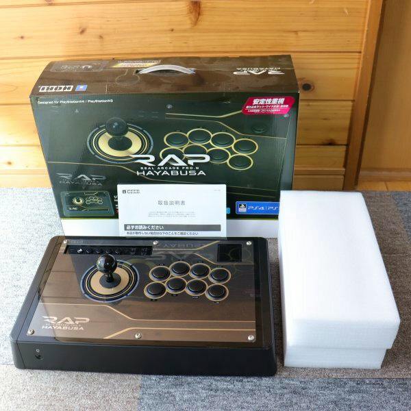 HORI Real Arcade Pro.V HAYABUSA joystick controller displayed with its box, manual, and foam packaging.