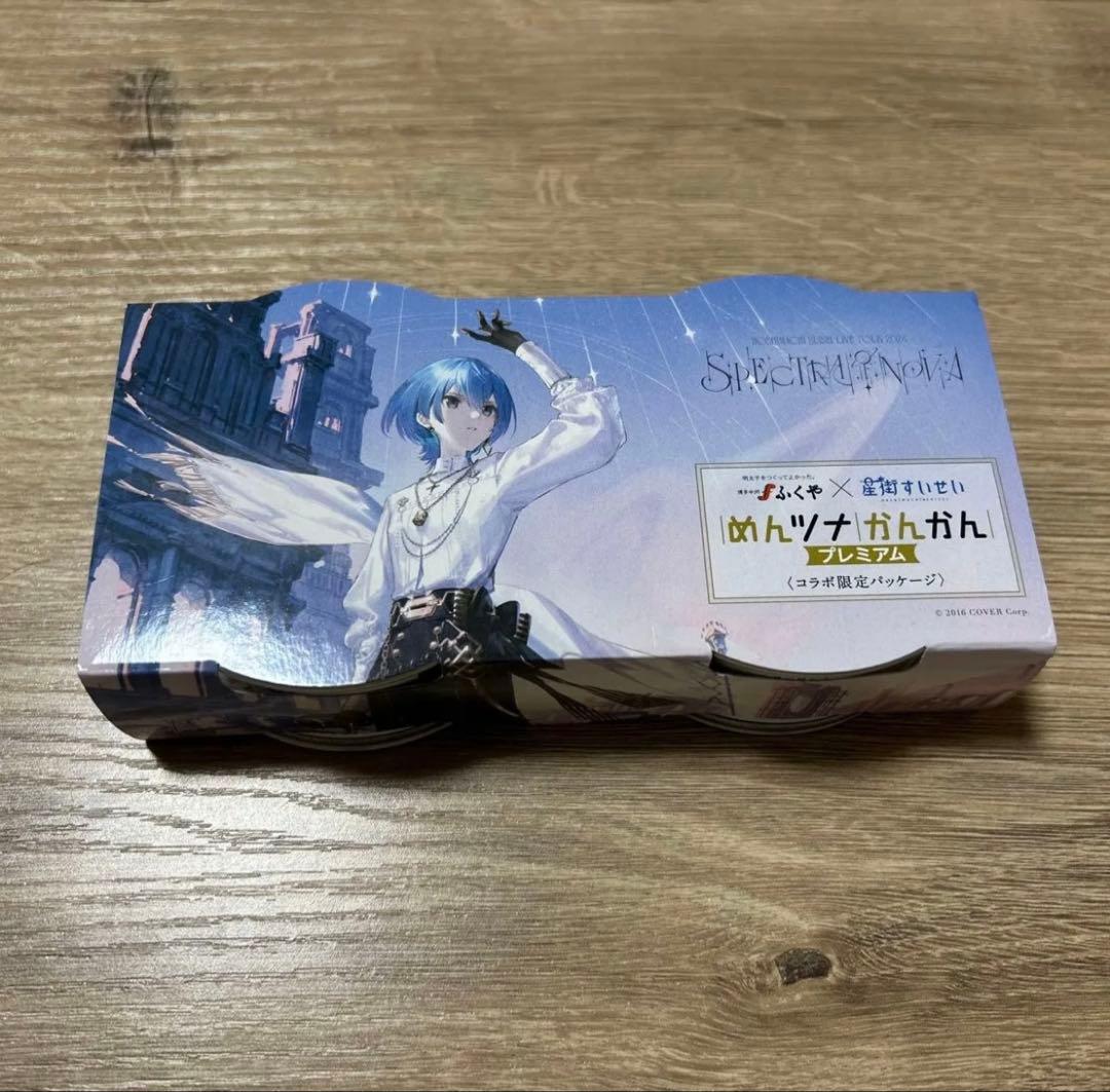 Boxed pack of canned tuna with Hololive 星街すいせい (Suisei) character artwork displayed on a wooden surface.