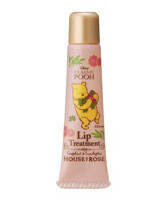 Front view of a pink tube of lip treatment featuring a Classic Pooh illustration and a gold cap.