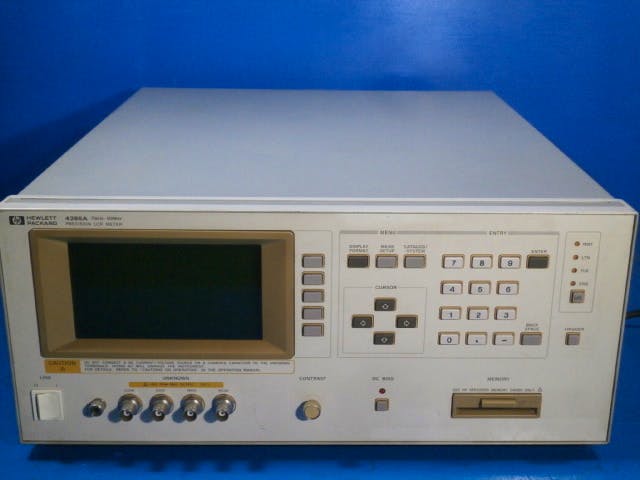 Front view of an HP 4285A precision LCR meter showing its display, keypad, control buttons, and front connectors.