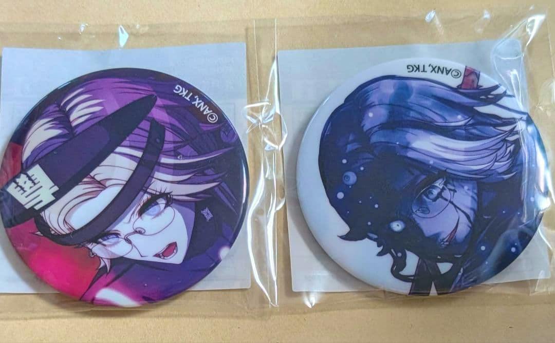 Packaged HUNDRED LINE can badges showing two round illustrated character designs, one purple-toned and one blue-toned.