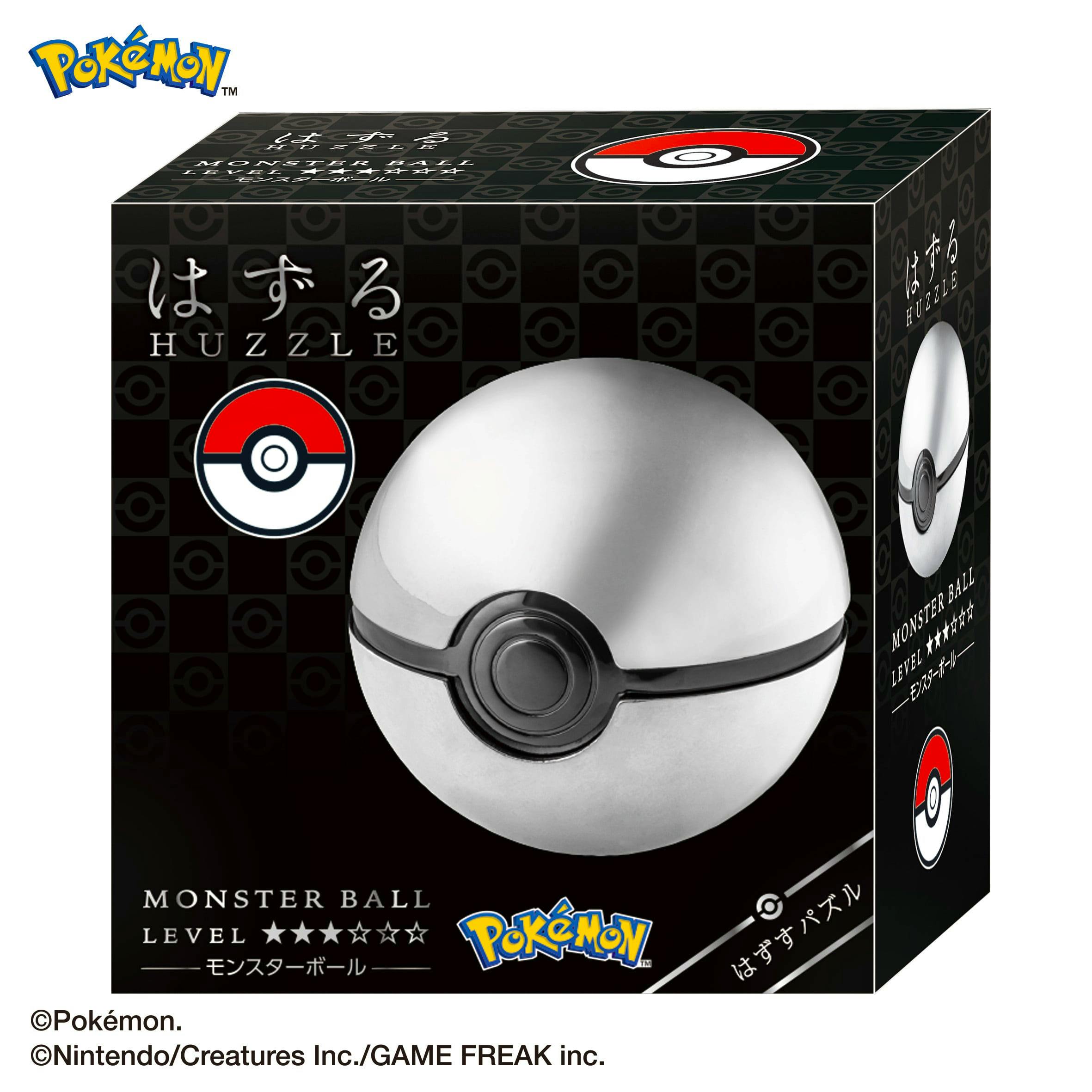Close-up of the boxed metal Pokémon Monster Ball (はずる モンスターボール) toy showing the ball and its black packaging.