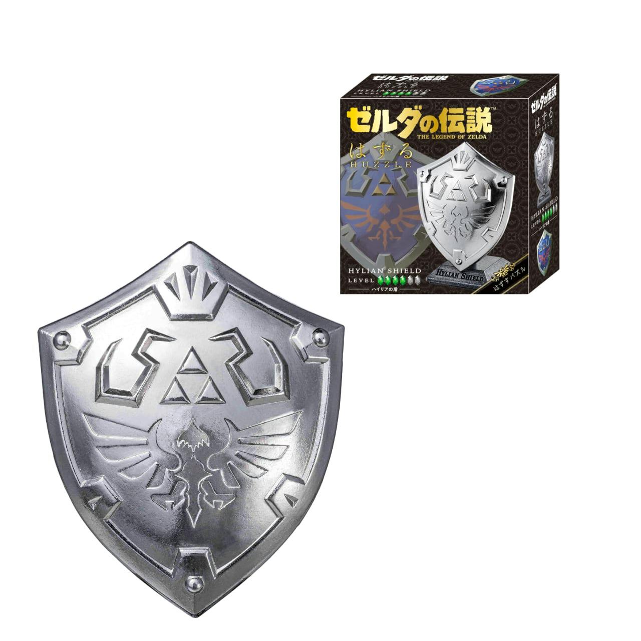 Silver Hylian Shield model (front view) with the product's boxed packaging shown at top right.