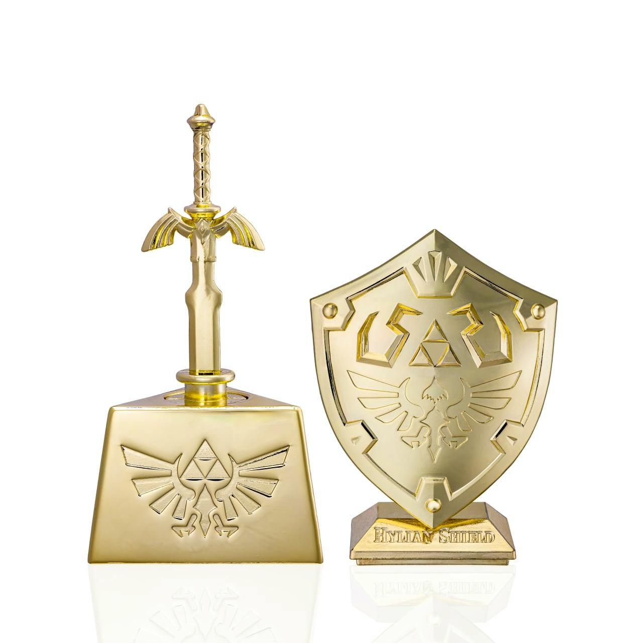 Gold-colored Master Sword and Hylian Shield figures from The Legend of Zelda Premium Gold Edition on a white background.