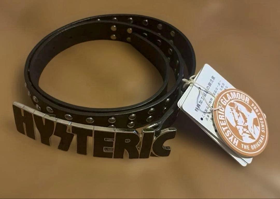 Coiled black studded belt with a metal "HYSTERIC" buckle and attached brand tags.